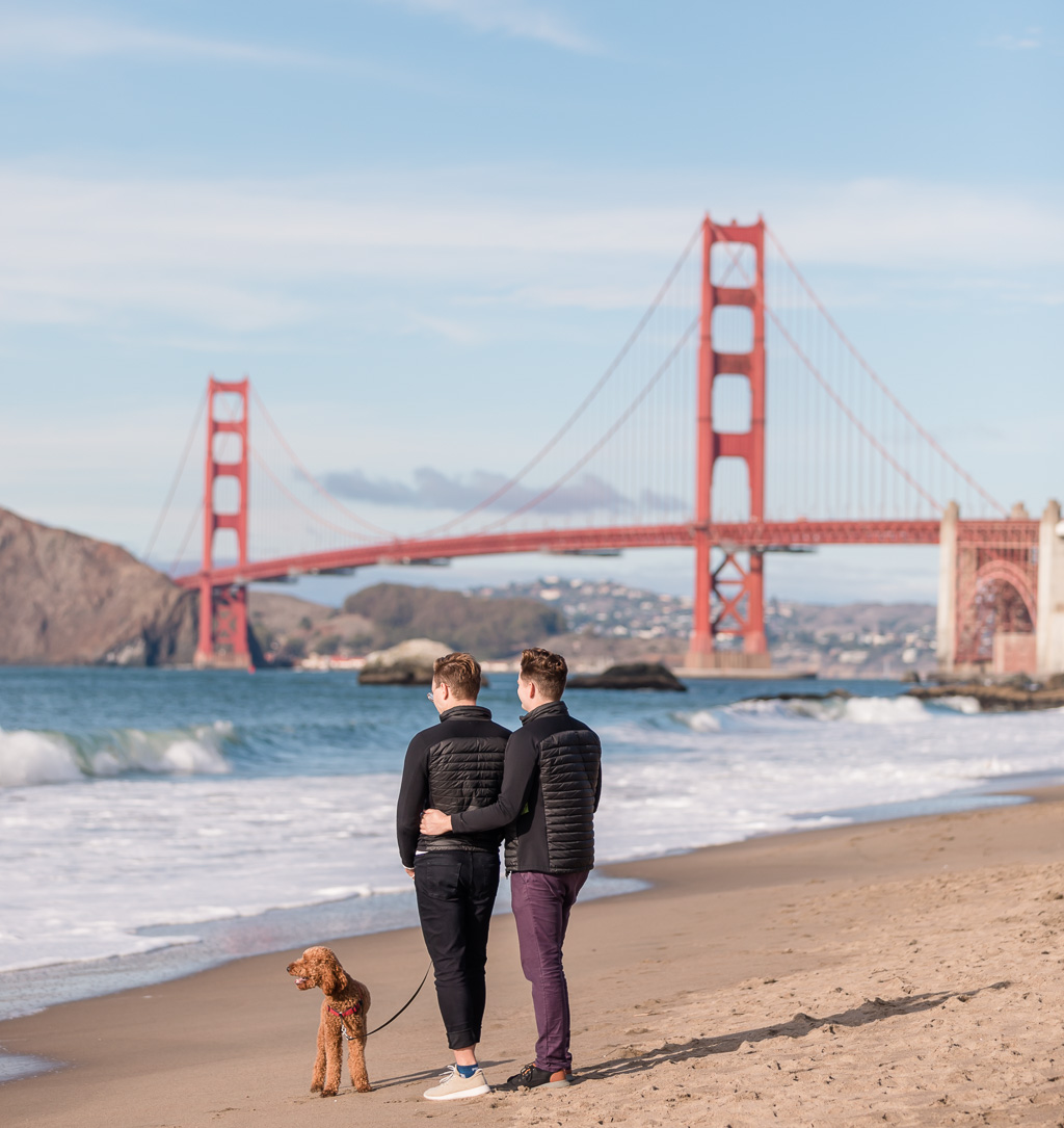 couple walking on Baker Beach with dog
