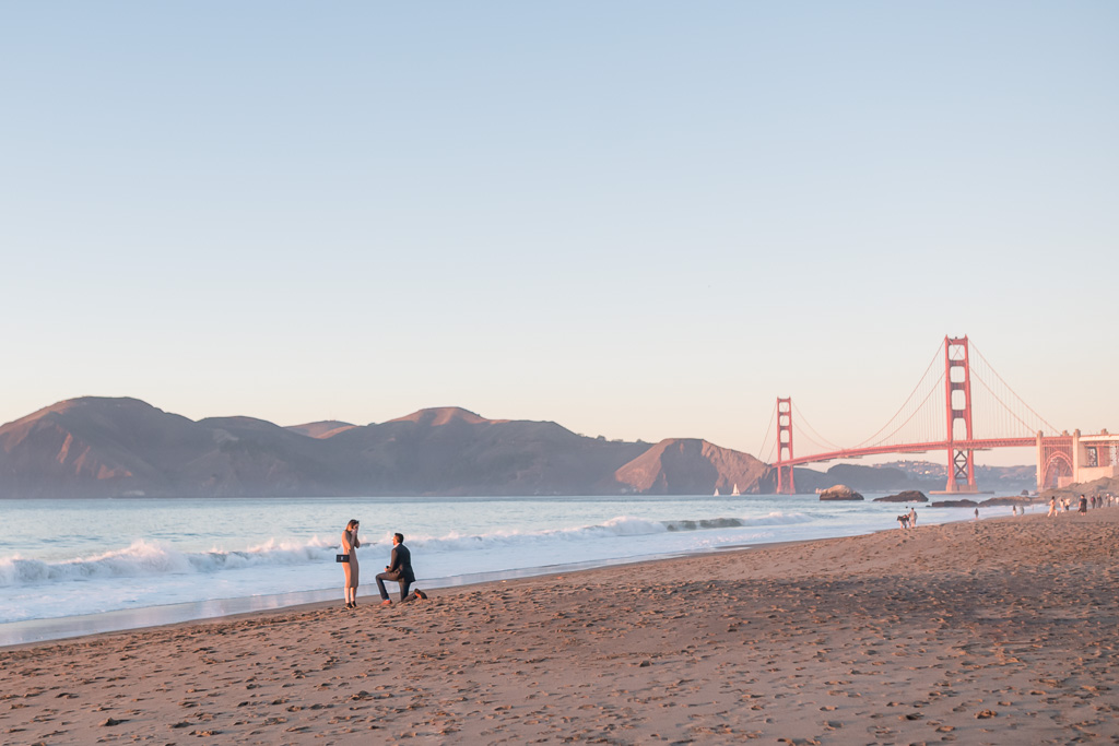 Baker Beach sunset surprise proposal in front of the ocean