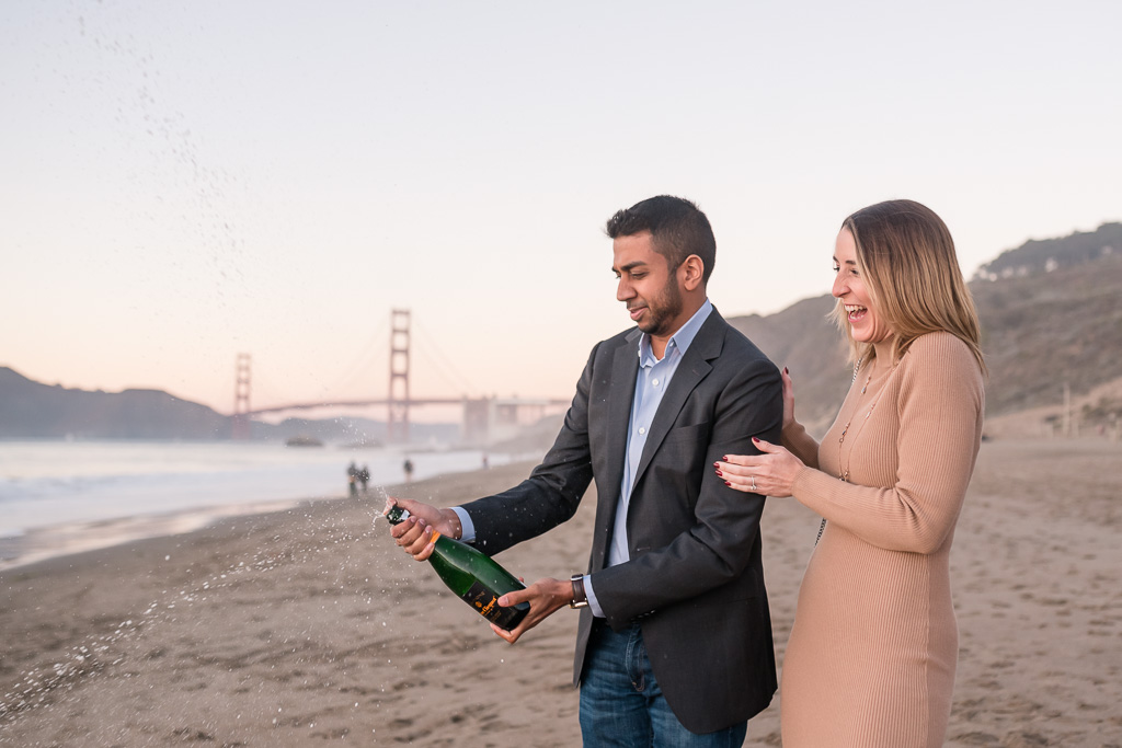 popping champagne to celebrate engagement
