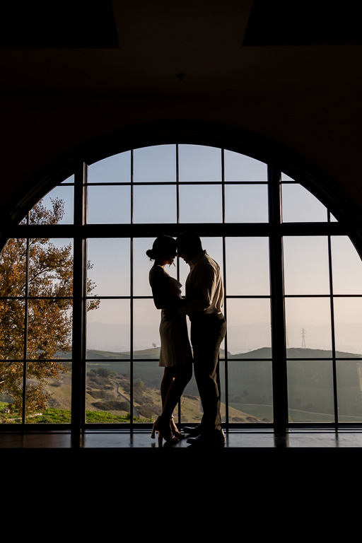 engagement photo silhouetted against window