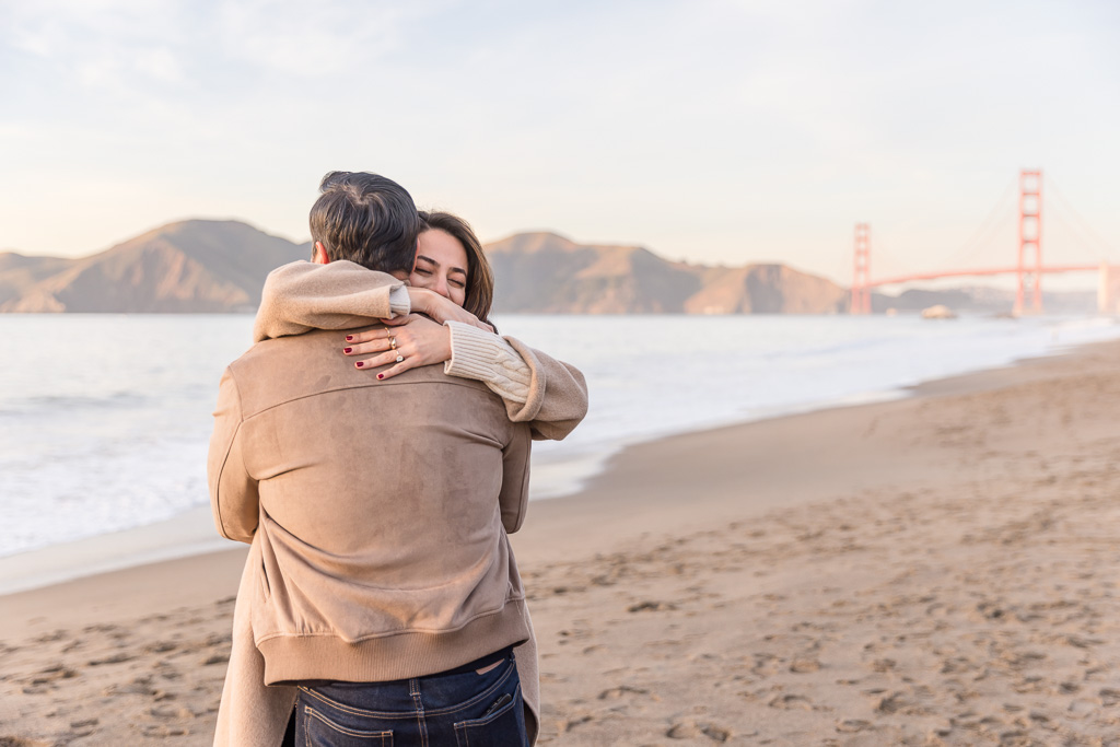 super happy couple just engaged at Baker Beach