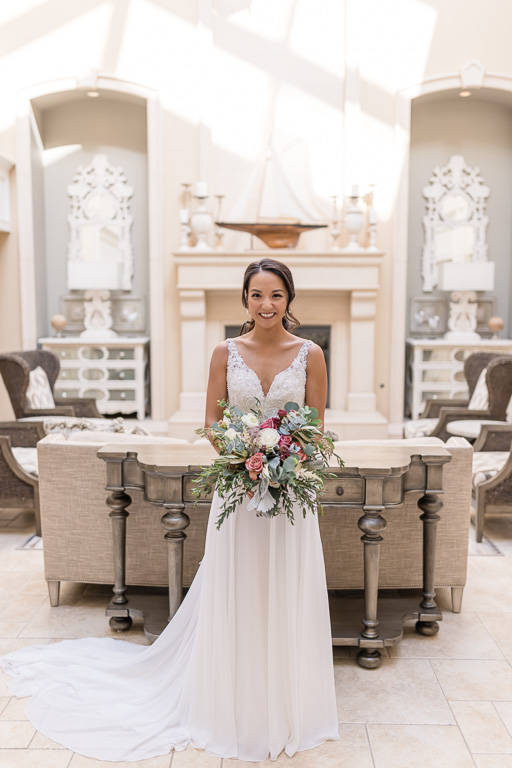 photo of the bride holding her bouquet in the Oceano Hotel main lobby