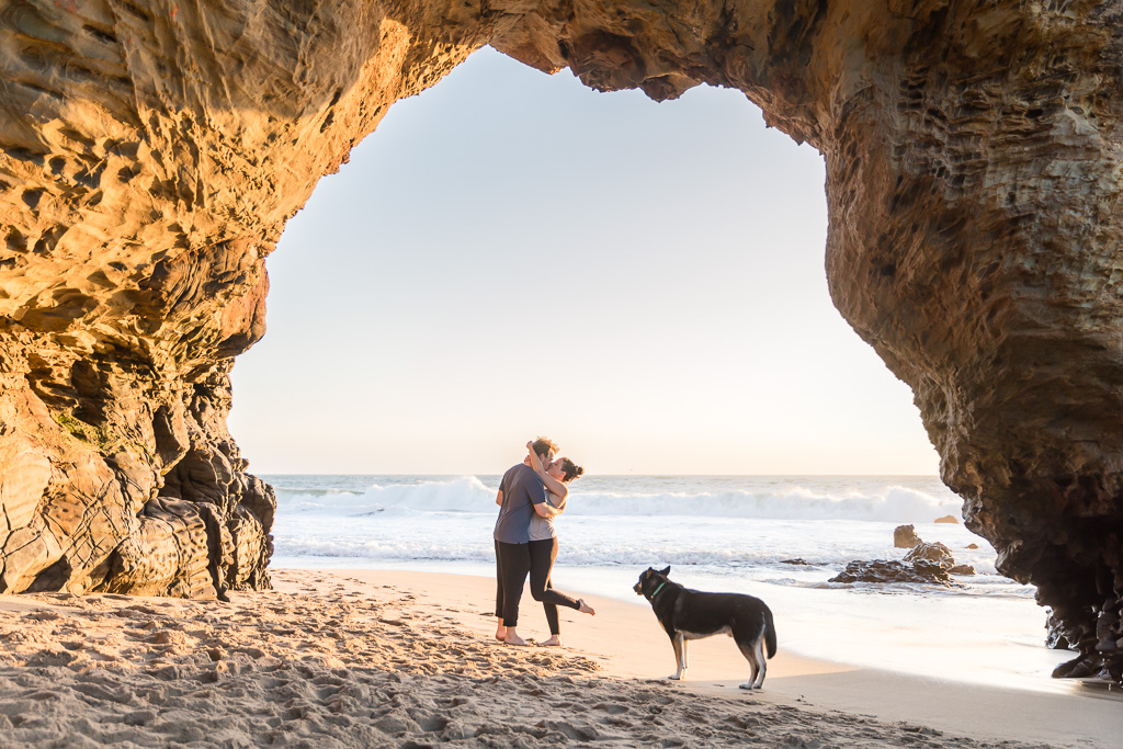 surprise engagement at Panther Beach under the rock arch