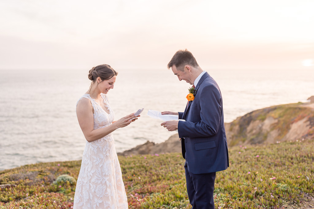 couple reading personal vows from each other