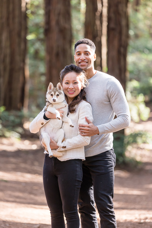 cute portrait of couple and puppy in a redwood forest