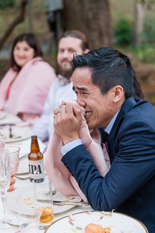wedding guest laughing at dinner toasts