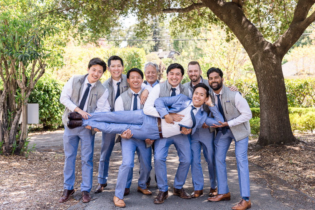 groomsmen carrying groom