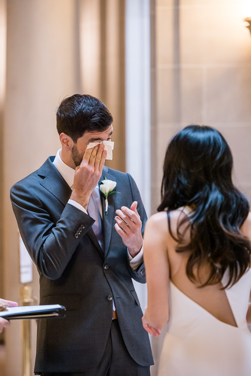 wiping tears awayduring City Hall civil ceremony