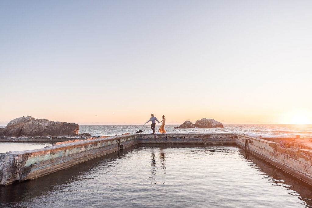 sunset engagement photos with dog walking at Sutro Baths