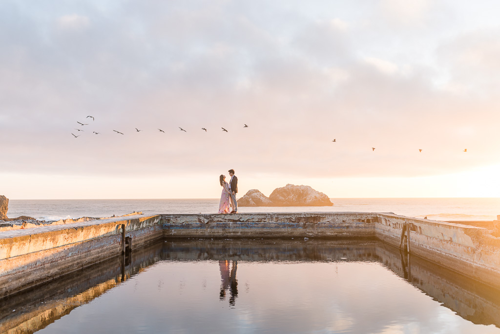 sunset photos of couple with birds flying overhead