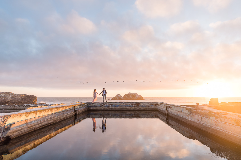 San Francisco engagement photos with epic colorful skies over the ocean at Sutro Baths