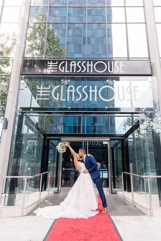 newlyweds celebrating in front of The GlassHouse SJ front entrance