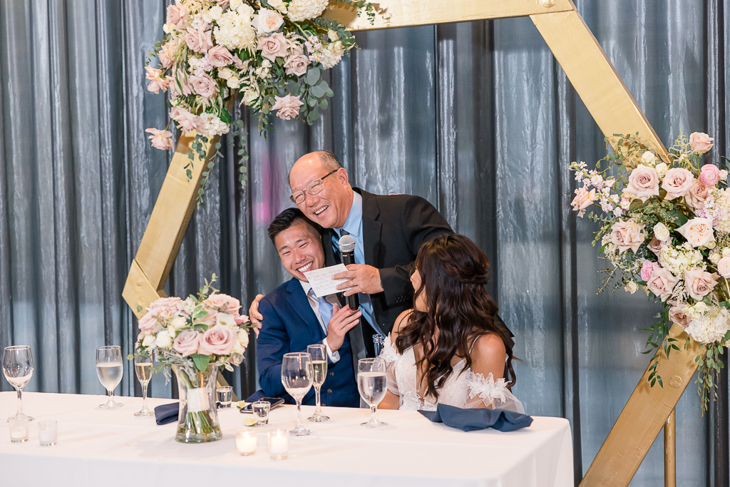 Dad giving toast and hugging groom