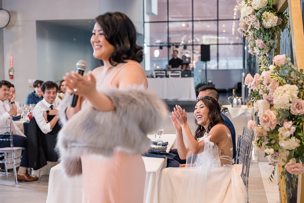 bride clapping at maid of honor speech
