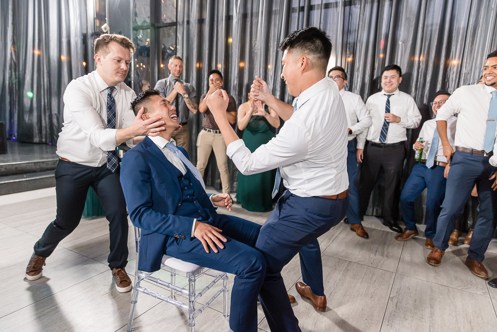 groomsman giving groom a lapdance