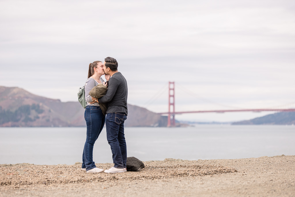faraway couple in front of Golden Gate Bridge