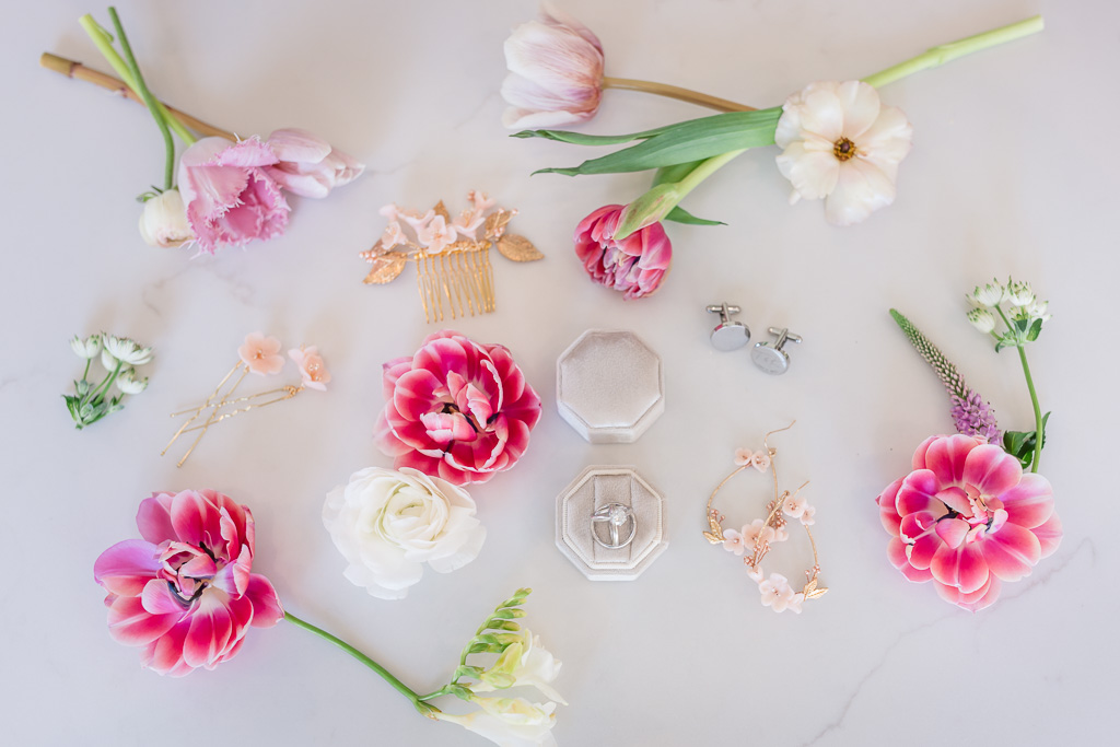 pretty flat lay with flowers, rings, wedding details