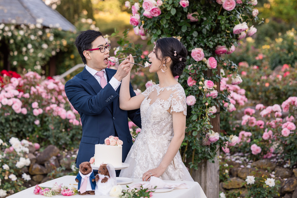 outdoor bride and groom cake feeding
