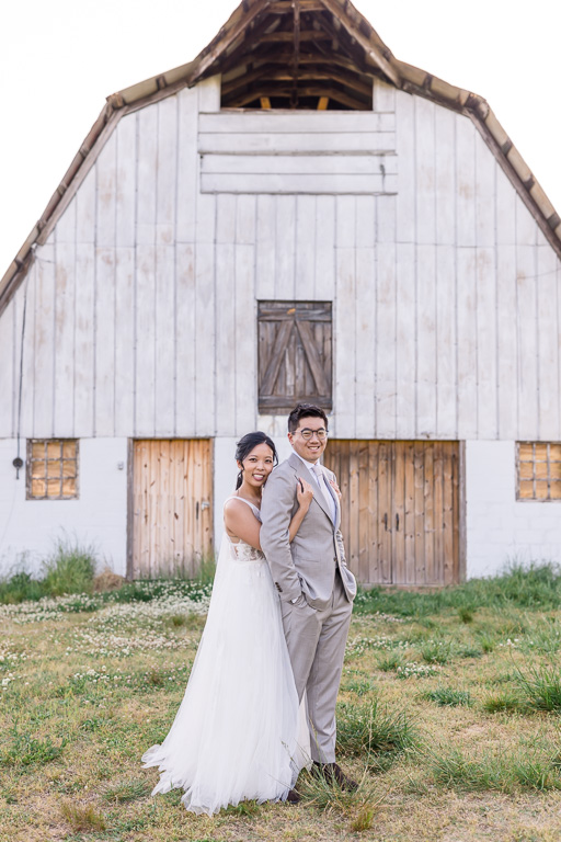 bride and groom at a rustic farm barn
