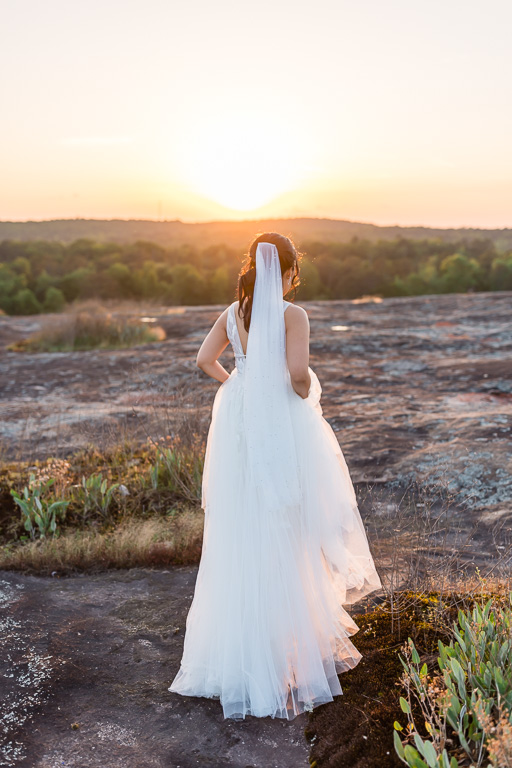 bride walking into the sunset at Arabia Mountain