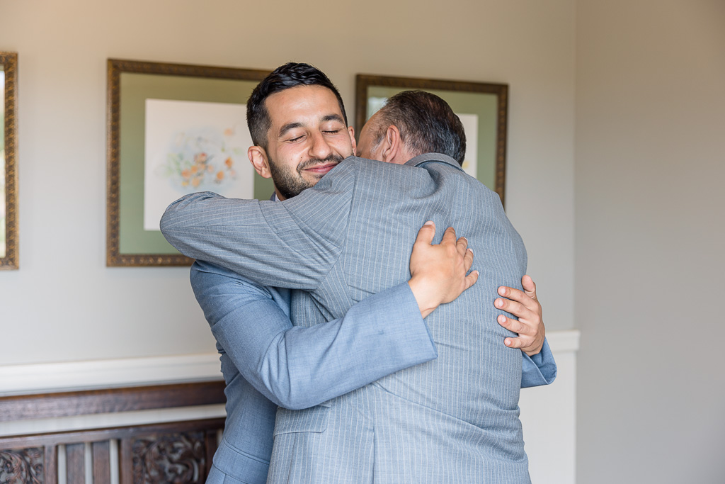 groom and dad hugging