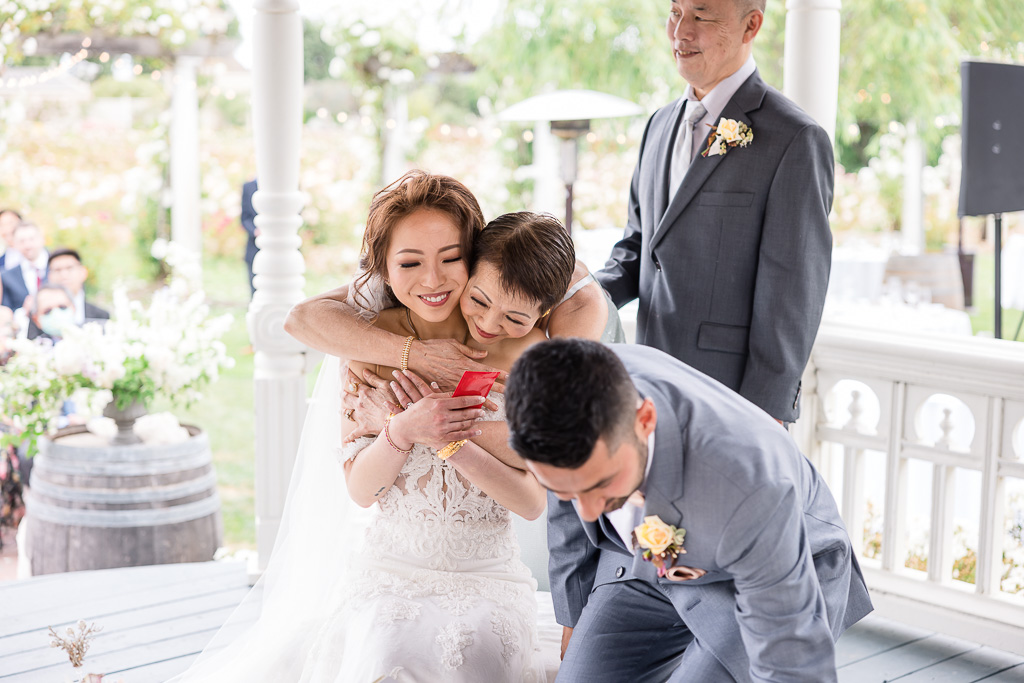 bride and her parents sharing a cute moment