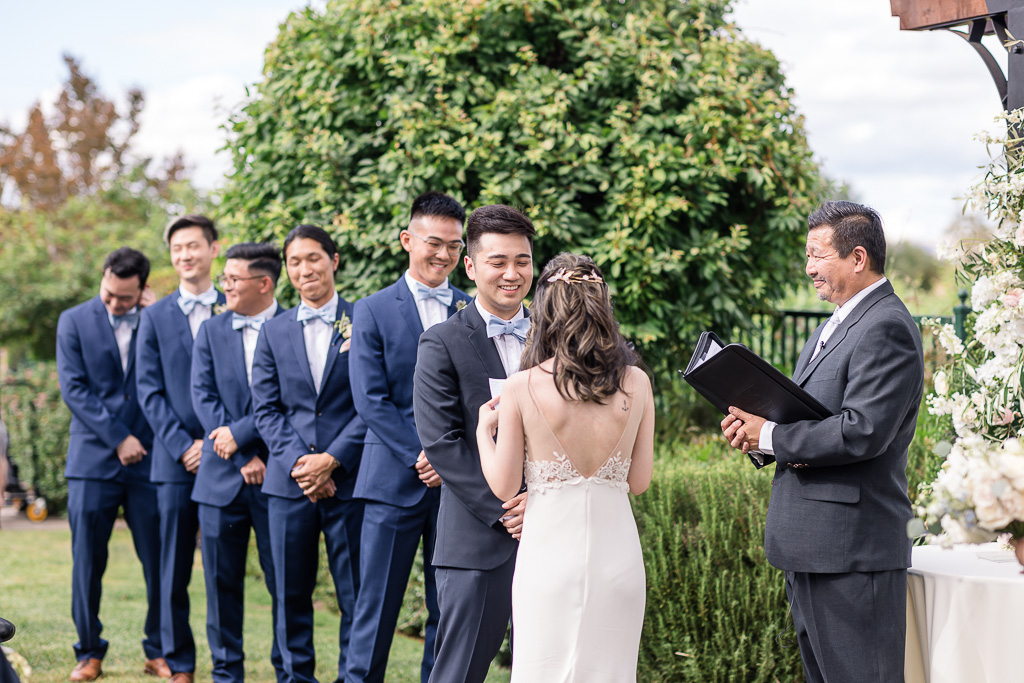 groom and groomsmen chuckling at a funnny moment during wedding ceremony