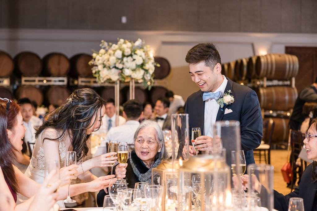 bride and groom greeting grandmother at wedding reception table