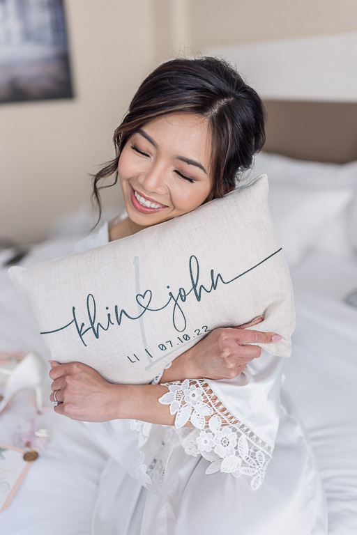 bride with customized monogrammed wedding pillow