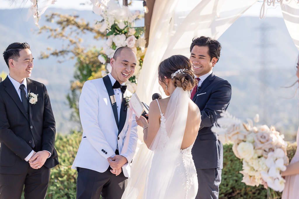 groom laughing at bride's wedding vows