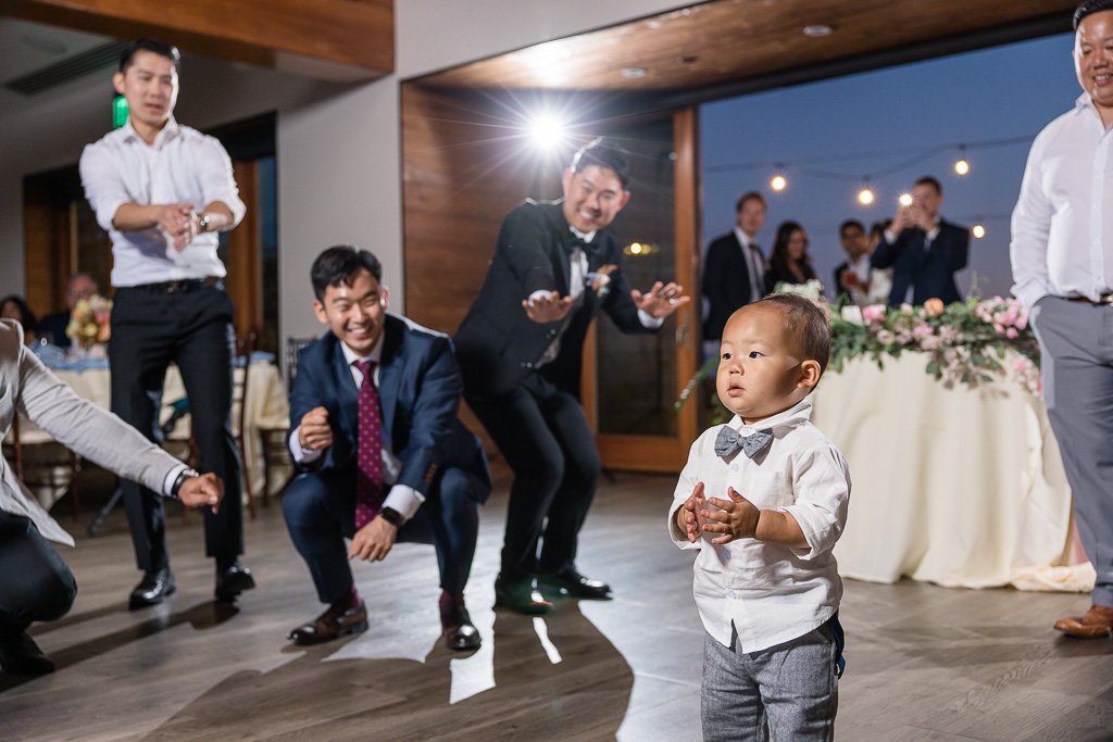 wedding guests cheering a little kid dancing