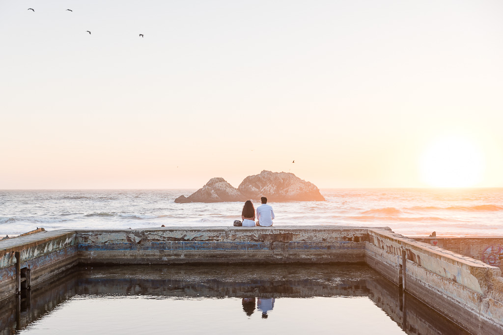 couple sitting on the edge of the water at Sutro Baths