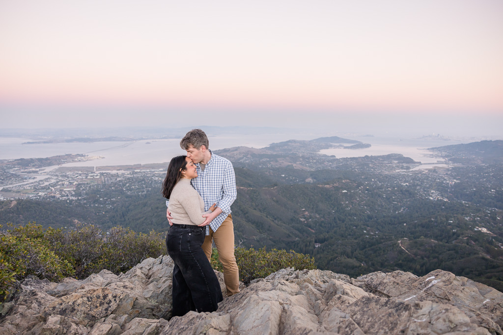 engagement photos on a rock at Mt Tam with amazing sunset sky