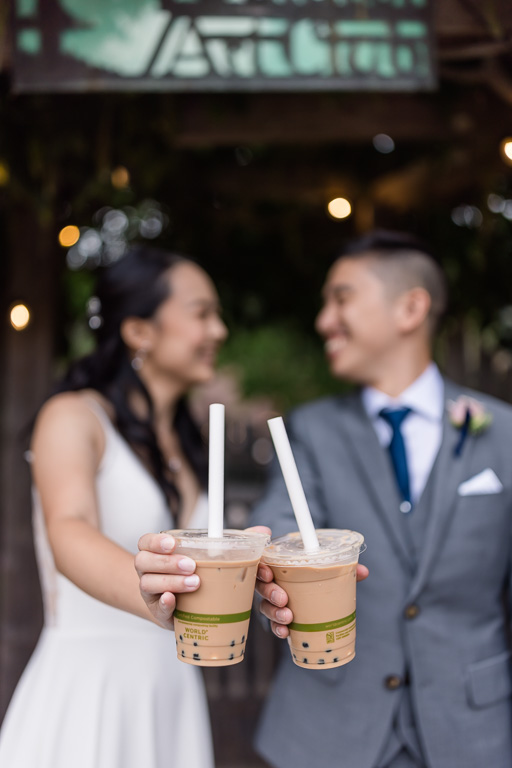 bride and groom holding boba