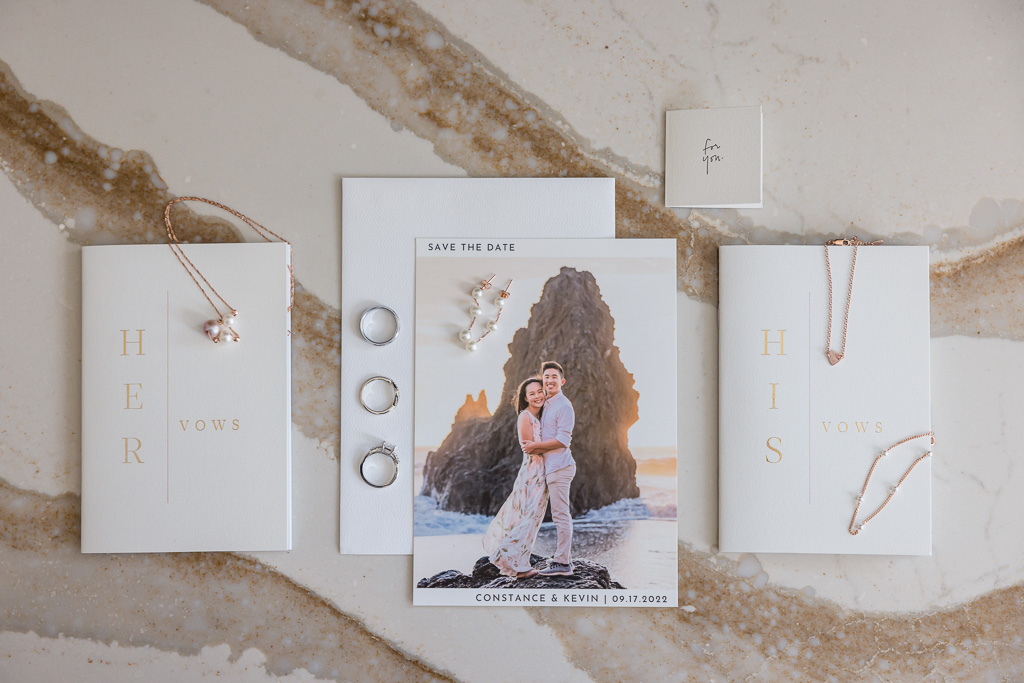 wedding invitation, save-the-date, and rings flat-lay