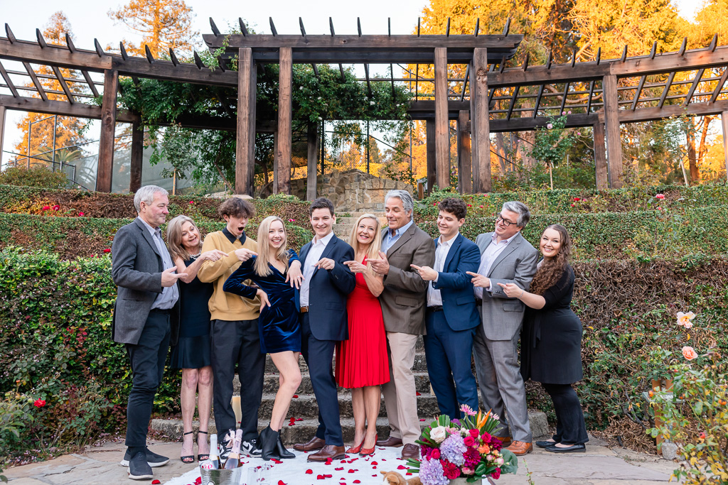 big family photo at proposal engagement celebration