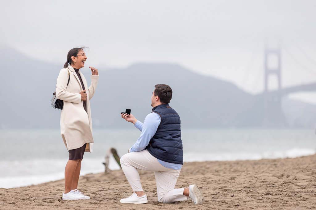 very happy excited reaction to surprise engagement at Baker Beach