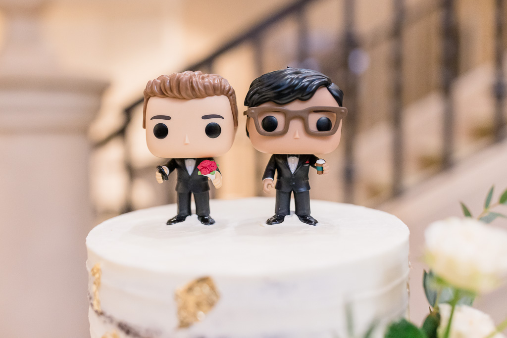 super cute cake topper of the grooms holding flowers and Starbucks coffee