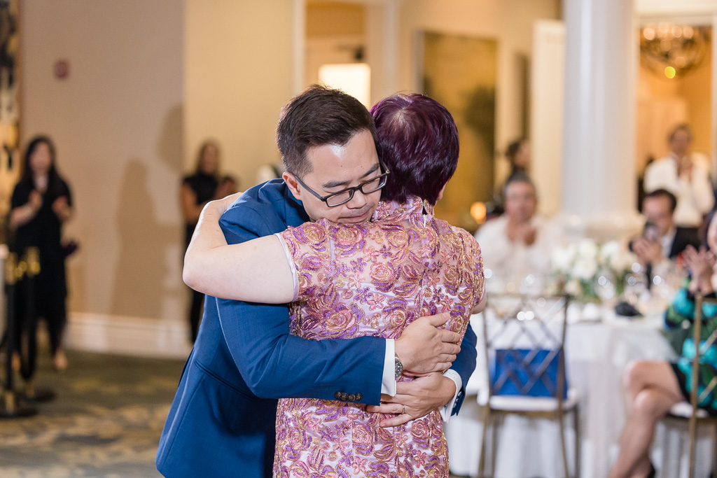 a very emotional hug between groom and mother