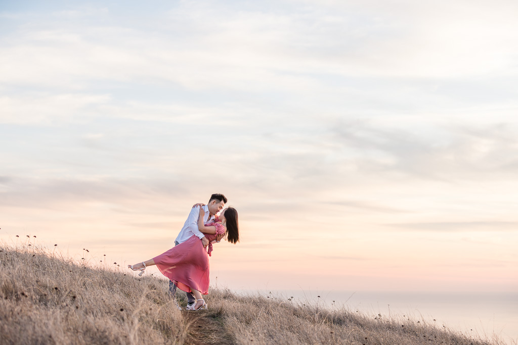 kissing in the Mt Tam grass with rainbow colored sky