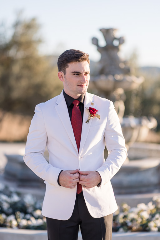 groom solo wearing a white jacket and black pants