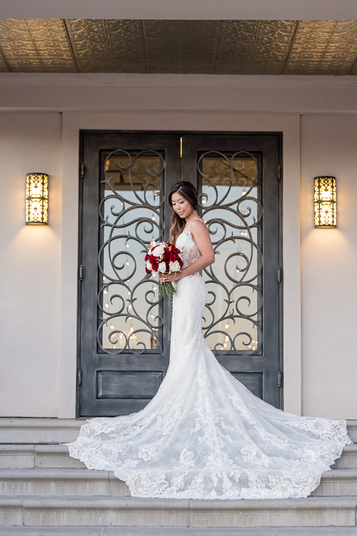 bride solo with red and white bouquet