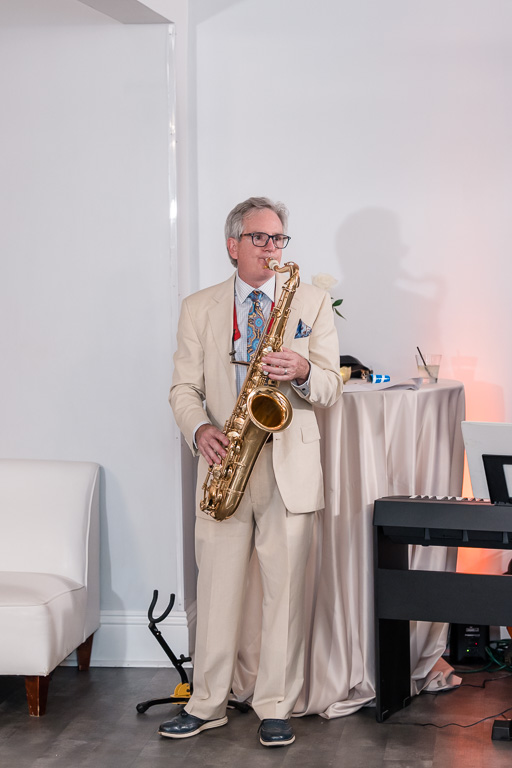 father of the groom playing saxophone