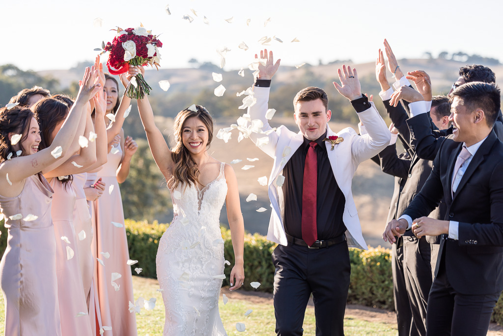 white flower petal toss photo with bride and groom
