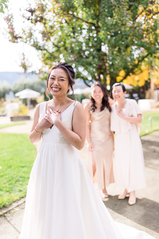 cute photo of bride giggling with bridesmaids in the background