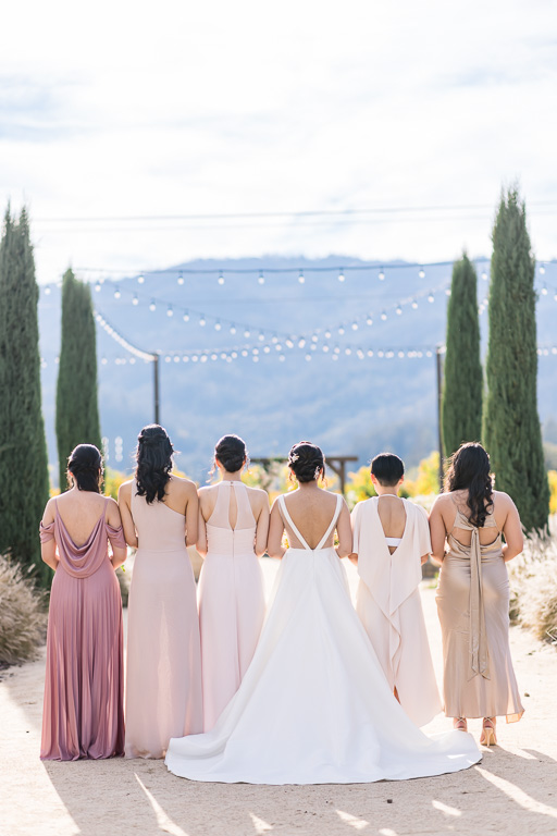shot of bride and bridesmaids from the back with beautiful sunlight
