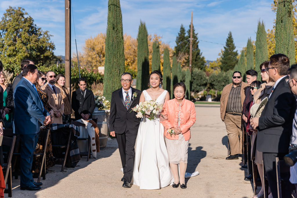 parents of the bride escorting her down the aisle