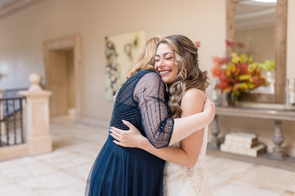 bride and mom hugging