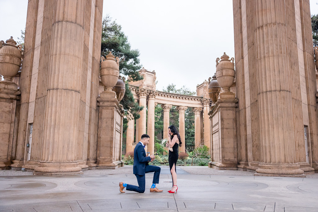 beautiful rainy San Francisco surprise proposal wearing black dress and red shoes