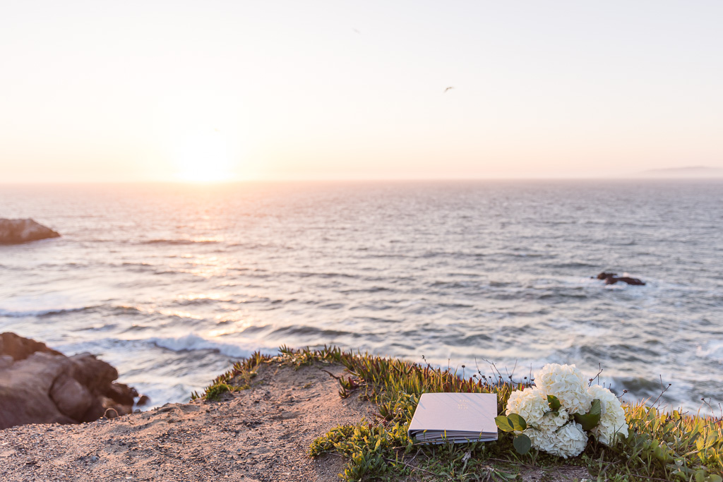 scrapbook and bouquet on a cliffside set up for a proposal